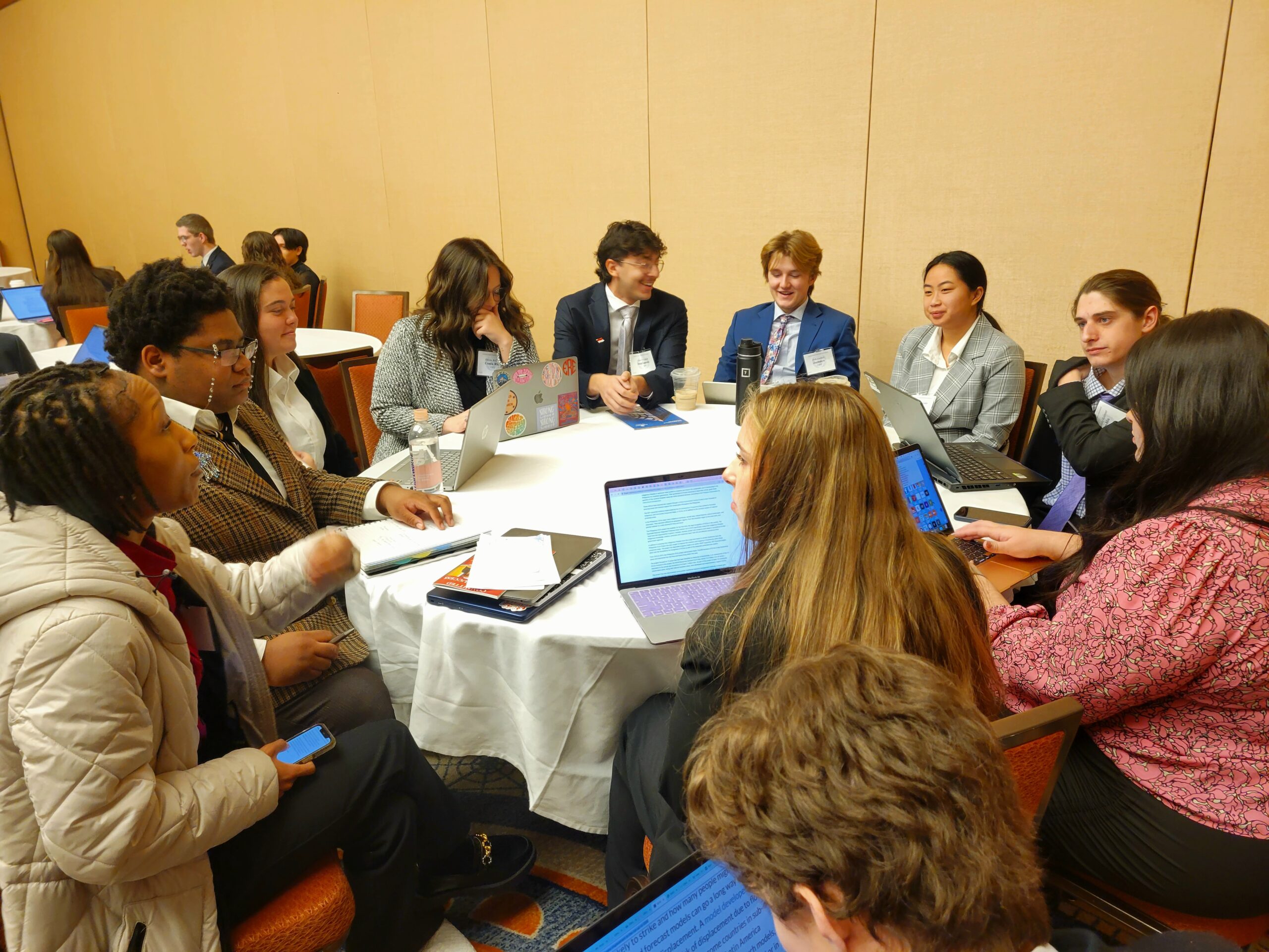 A group of Representatives meeting around a large circular table.